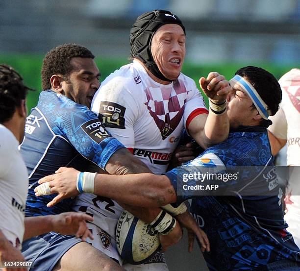 Bordeaux Begles' player Lachie Munro vies with Montpellier's Maximiliano Bustos and Timoci Nagusa during the French Top 14 rugby Union match...