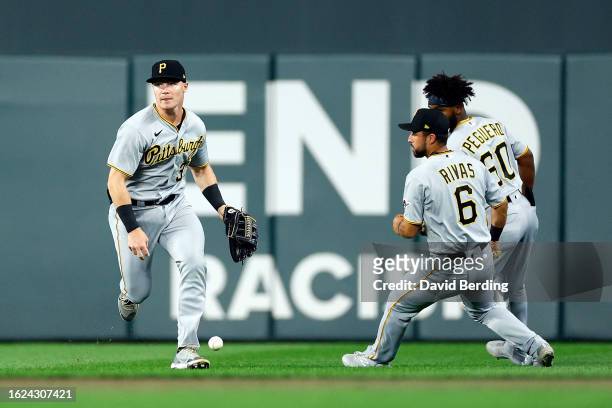 Henry Davis, Alfonso Rivas, and Liover Peguero of the Pittsburgh Pirates can't field a ball hit by Jorge Polanco of the Minnesota Twins for an RBI...
