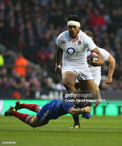 Morgan Parra of France tackles Manu Tuilagi of England during the RBS Six Nations match between England and France at Twickenham Stadium on February...