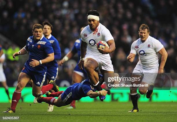 Morgan Parra of France tackles Manu Tuilagi of England during the RBS Six Nations match between England and France at Twickenham Stadium on February...