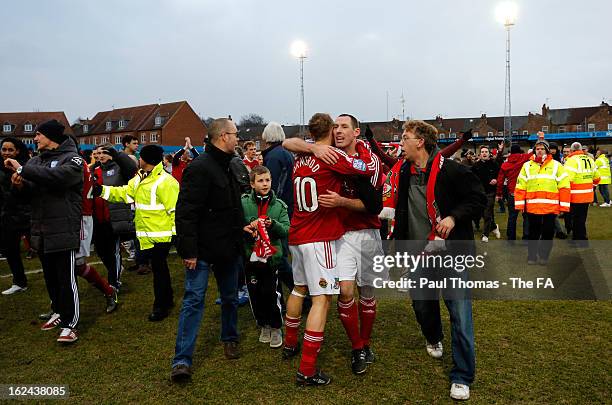 Stephen Wright and Brett Ormerod celebrabrate as fans invade the pitch at full time of the FA Trophy semi final second leg match between Gainsborough...