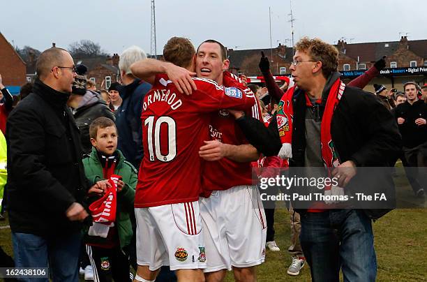 Stephen Wright and Brett Ormerod celebrate as fans invade the pitch at full time of the FA Trophy semi final second leg match between Gainsborough...