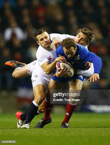 Frederic Michalak of France is tackled by Danny Care and Toby Flood of England during the RBS Six Nations match between England and France at...