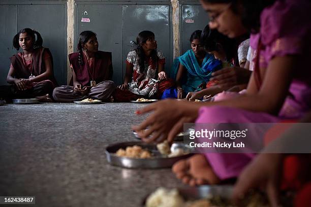 Students eat during lunch at the Aarti Home shelter on February 23, 2013 in Kadapa, India. Female infanticide is still prevalent in rural areas of...