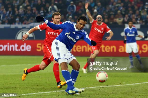 Joel Matip of Schalke scores the second goal against Adam Bodzek of Duesseldorf during the Bundesliga match between FC Schalke 04 and Fortuna...
