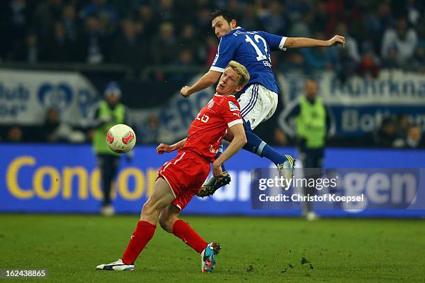 Marco Hoeger of Schalke challenges Axel bellinghausen of Duesseldorf during the Bundesliga match between FC Schalke 04 and Fortuna Duesseldorf at...