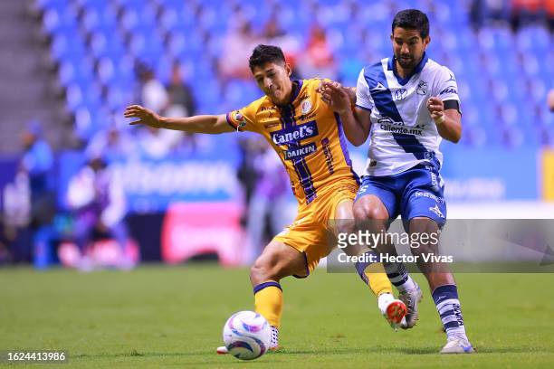 Angel Zaldivar of Atletico San Luis battles for possession with Diego de Buen of Puebla during the 4th round match between Puebla and Atletico San...