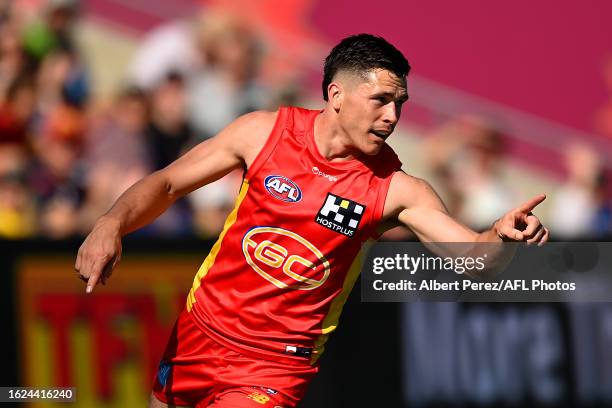 Ben Ainsworth of the Suns celebrates kicking a goal during the round 23 AFL match between Gold Coast Suns and Carlton Blues at Heritage Bank Stadium,...