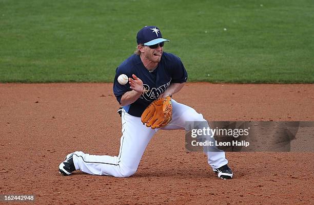 Mike Fontenot of the Tampa Bay Rays attempts to make the play as the ball bounces off his chest into left field during the game against the...