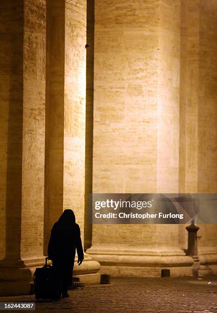 Nun walks along the collonade in Saint Peter's Square on February 23, 2013 in Vatican City, Vatican. Pope Benedict XVI is due to hold his last...