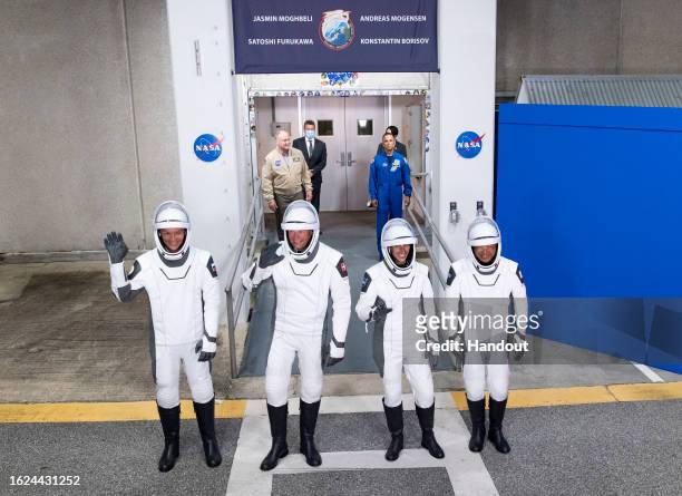 In this handout image provided by NASA, Roscosmos cosmonaut Konstantin Borisov, left, ESA astronaut Andreas Mogensen, second from left, NASA...