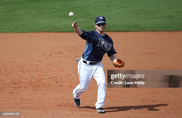 Mike Fontenot of the Tampa Bay Rays makes the throw to first base during the Spring Training game against the Pittsburgh Pirates on February 23, 2013...