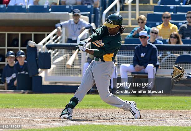 Jemile Weeks of the Oakland Athletics hits a double in the spring training game against the Milwaukee Brewers at Maryvale Baseball Park on February...