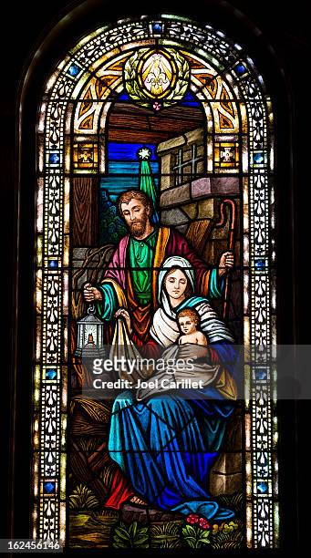 joseph, mary, and baby jesus in stained glass - virgin mary stock pictures, royalty-free photos & images