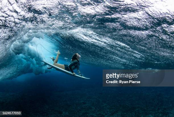 Australian surfer Olivia Ottaway dives under a wave on August 19, 2023 in Teahupo'o, French Polynesia. Teahupo'o has been hosting the WSL Tahiti Pro...