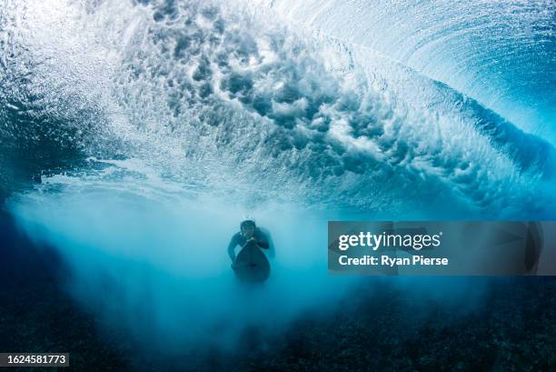 Australian surfer Olivia Ottaway dives under a breaking wave on August 19, 2023 in Teahupo'o, French Polynesia. Teahupo'o has been hosting the WSL...