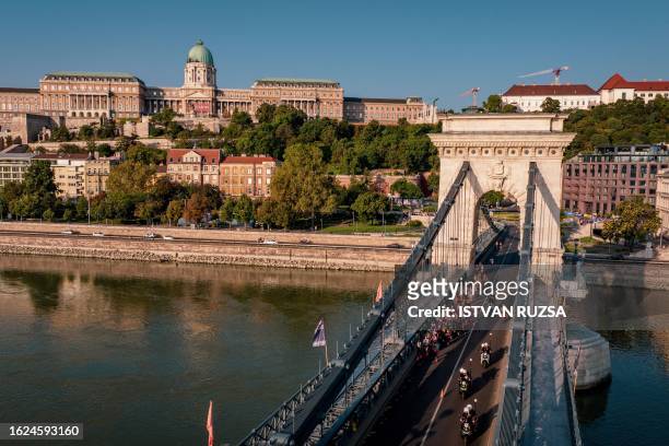 This aerial picture taken on August 26, 2023 shows athletes running across the Chain Bridge as they compete in the women's marathon final during the...