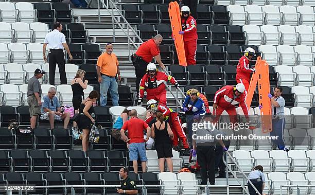 Emergency help injured spectators in the upper level of the front grandstand at Daytona International Speedway after a wreck on the final lap of the...