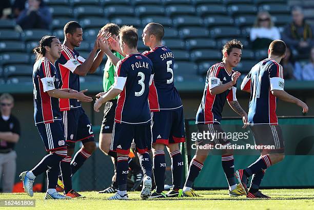Jerry Bengtson of the New England Revolution celebrates with Tyler Polak and A.J. Soares after scoring a first half goal against the New York Red...