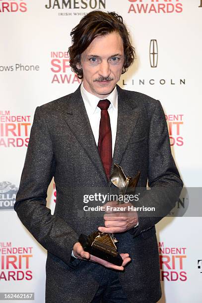 Actor John Hawkes poses with the Best Male Lead award for 'The Sessions' in the press room during the 2013 Film Independent Spirit Awards at Santa...