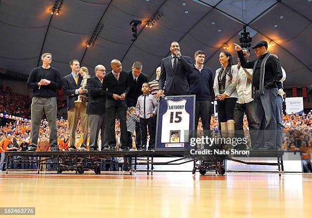 Former Syracuse Orange player Carmelo Anthony looks on with athletic director Daryl Gross, son Kiyan Carmelo Anthony and wife Alani Vasquez along...