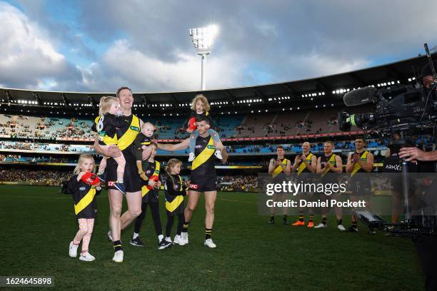 Jack Riewoldt of the Tigers and Trent Cotchin of the Tigers walk off the ground after playing their final games during the round 23 AFL match between...