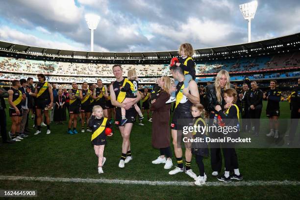 Jack Riewoldt of the Tigers and Trent Cotchin of the Tigers walk off the ground after playing their final games during the round 23 AFL match between...