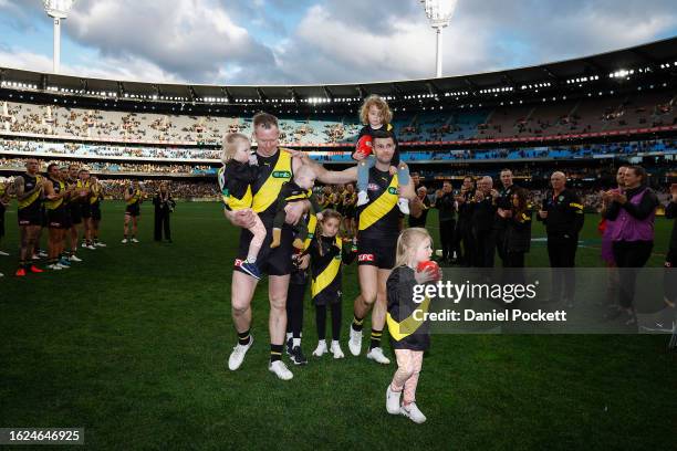 Jack Riewoldt of the Tigers and Trent Cotchin of the Tigers walk off the ground after playing their final games during the round 23 AFL match between...