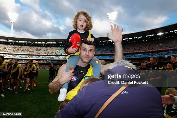 Teary eyed Trent Cotchin of the Tigers waves to fans as he walks a lap of honour with his family after playing his final game during the round 23 AFL...