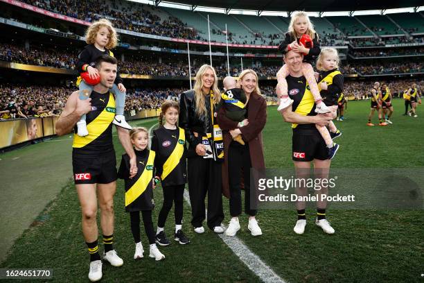 Jack Riewoldt and Trent Cotchin of the Tigers walk a lap of honour with their families after playing their final games during the round 23 AFL match...