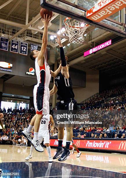 Guard Kyle Dranginis of the Gonzaga Bulldogs goes to the hoop over John Sinis of the San Diego Toreros during the first half of the game at McCarthey...