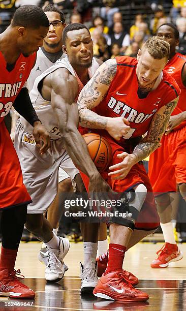 Wichita State's Ehimen Orukpe knocks the ball loose from Detroit's Nick Minnerath, right, in the second half at Koch Arena in Wichita, Kansas, on...