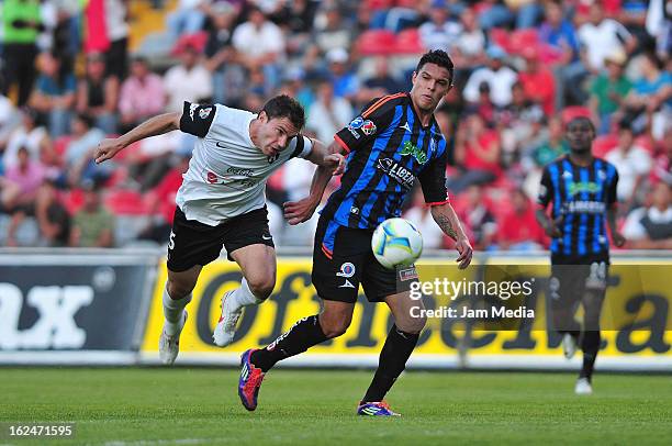 Leandro Cufre of Atlas struggles for the ball with Luis Angel Landin of Queretaro during a match 2013 Clausura Liga MX at La Corregidora Stadium on...