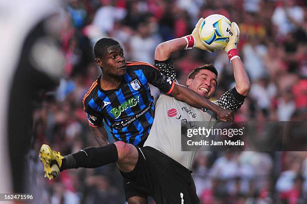 Miguel Pinto of Atlas struggles for the ball with Wilberto Cosme of Queretaro during a match 2013 Clausura Liga MX at La Corregidora Stadium on...