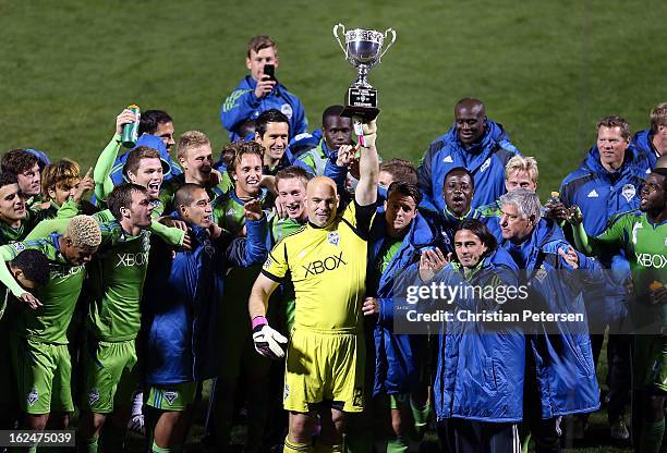 Goalkeeper Marcus Hahnemann of the Seattle Sounders holds up the FC Tucson Desert Diamond Cup alongside teammates after defeating Real Salt Lake 1-0...