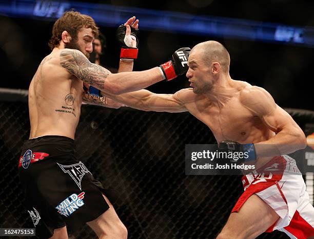 Anton Kuivanen punches Michael Chiesa in their lightweight bout during UFC 157 at Honda Center on February 23, 2013 in Anaheim, California.