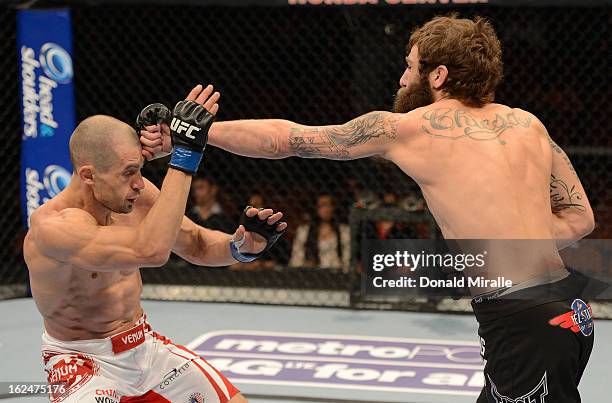 Michael Chiesa punches Anton Kuivanen in their lightweight bout during UFC 157 at Honda Center on February 23, 2013 in Anaheim, California.