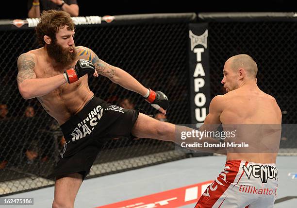 Michael Chiesa kicks Anton Kuivanen in their lightweight bout during UFC 157 at Honda Center on February 23, 2013 in Anaheim, California.