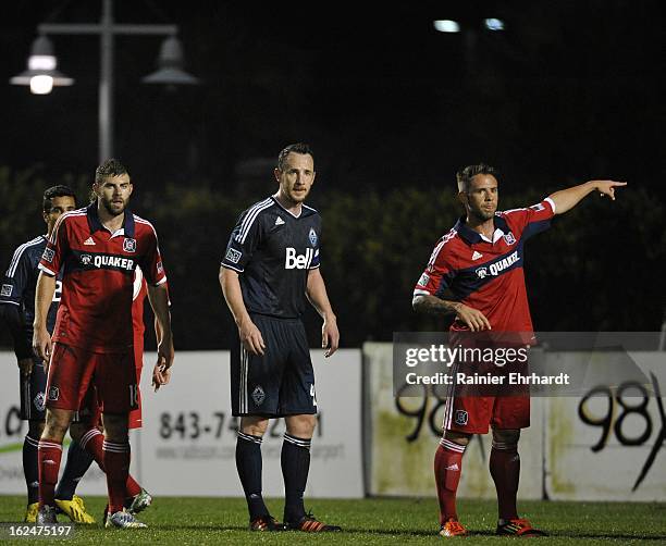 Daniel Paladini of the Chicago Fire points during a free kick as teammate Steven Kinney and Andy O'Brien of the Vancouver Whitecaps FC look on during...