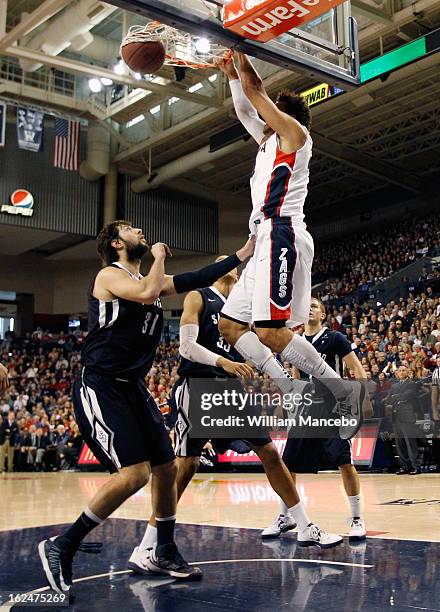 Forward Elias Harris of the Gonzaga Bulldogs dunks while John Sinis and Jito Kok of the San Diego Toreros defend during the first half of the game at...