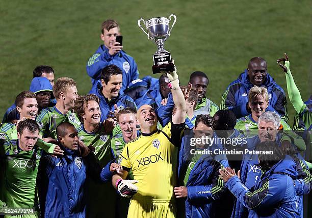 Goalkeeper Marcus Hahnemann of the Seattle Sounders holds up the FC Tucson Desert Diamond Cup alongside teammates after defeating Real Salt Lake 1-0...