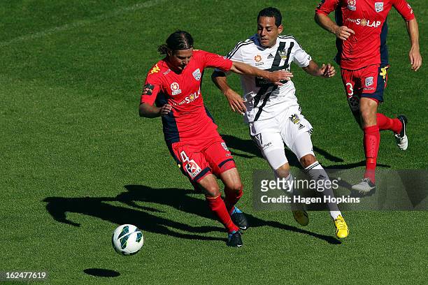 Jon McKain of Adelaide holds off the efence of Leo Bertos of the Phoenix during the round 22 A-League match between the Wellington Phoenix and...