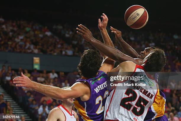 Darnell Lazare and Kevin White of the Kings compete for the ball with Jeremiah Trueman of the Wildcats during the round 20 NBL match between the...