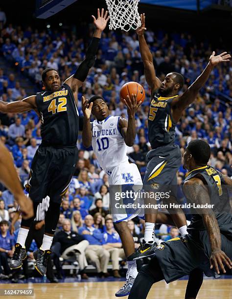 Kentucky's Archie Goodwin draws a foul as he splits Missouri's Alex Oriakhi and Keion Bell at Rupp Arena in Lexington, Kentucky, Saturday, February...