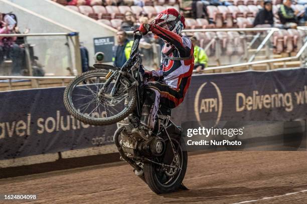 Freddy Hodder celebrates with a wheelie during the National Development League match between Belle Vue Colts and Workington Comets at the National...