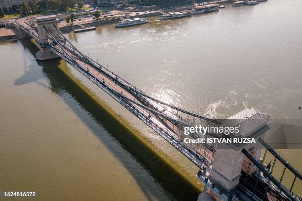 This aerial picture taken on August 26, 2023 shows athletes running across the Chain Bridge while competing in the women's marathon final during the...