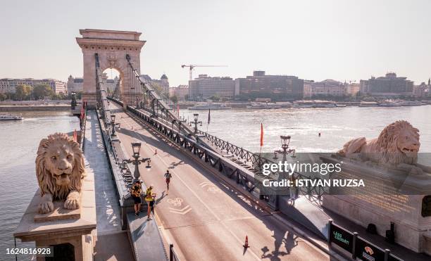 This aerial picture taken on August 26, 2023 shows athletes running across the Chain Bridge while competing in the women's marathon final during the...