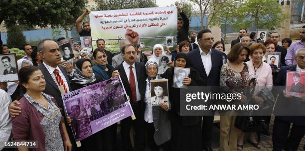Lebanese officials and relatives of victims of the civil war attend a rally in Beirut on April 11, 2010 to mark the 35th anniversary of the outbreak...