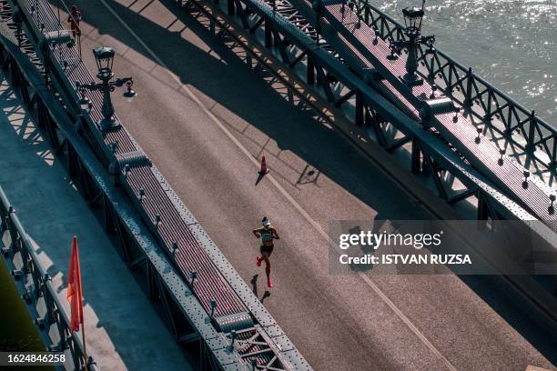 This aerial picture taken on August 26, 2023 shows Australia's Sarah Klein running across the Chain Bridge in the women's marathon final during the...