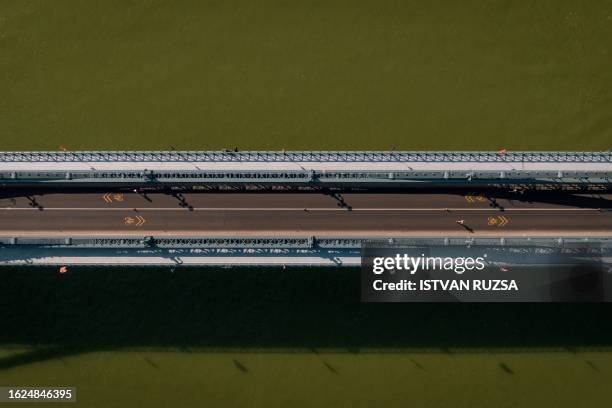 This aerial picture taken on August 26, 2023 shows athletes running across the Chain Bridge as they compete in the women's marathon final during the...